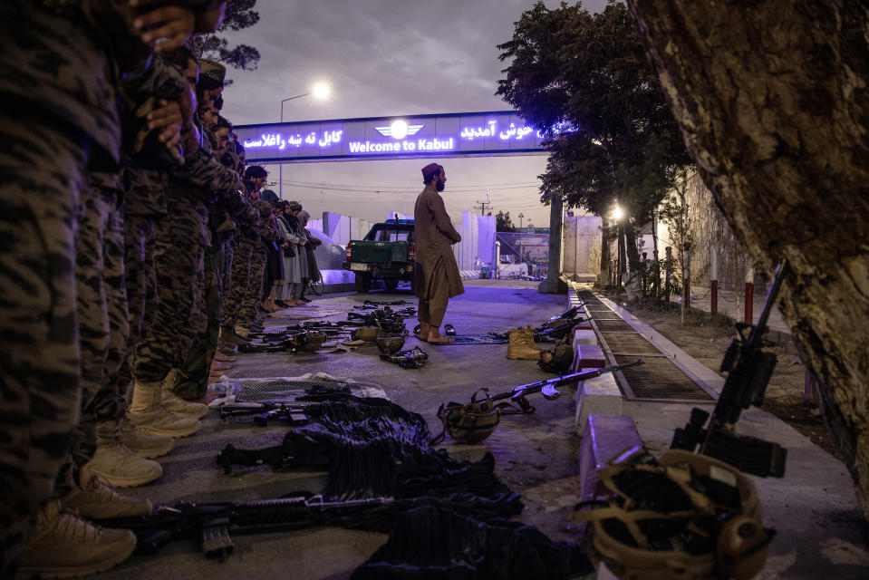 Members of the Badri 313 Battalion, a group of Taliban fighters, stand during evening prayers near Hamid Karzai International Airport in Kabul on Aug. 28.<span class="copyright">Jim Huylebroek—The New York Times/Redux</span>