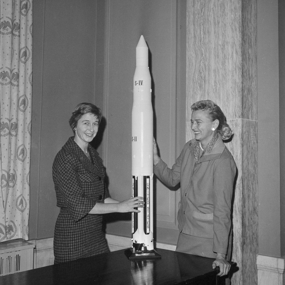 FILE - In this March 13, 1962 file photo, Jane Hart, left, wife of Sen. Philip Hart, D-Mich., and Jerrie Cobb of Oklahoma City pose with a model of a Saturn rocket at Capitol Hill in Washington. Two days later, they met with Vice President Lyndon B. Johnson in an effort to have the U.S. launch a program for female astronauts. Both women had successfully passed the physical tests given to male astronauts. Cobb, NASA’s first female astronaut candidate, died in Florida at the age of 88 on March 18, 2019.(AP Photo/Henry Griffin)