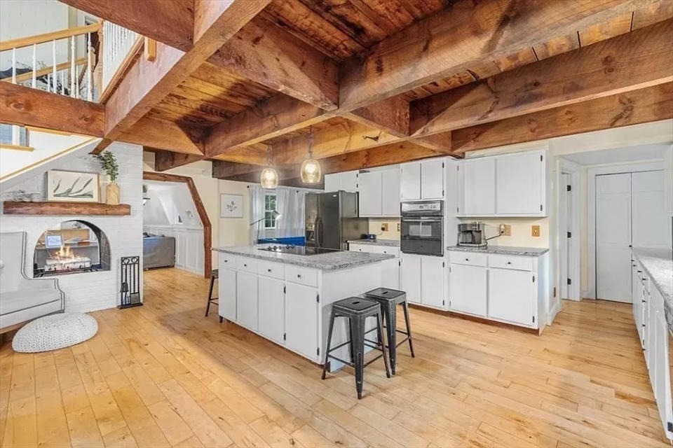 This house at 206 Central St. in Abington that sold for $636,000 on Feb. 23, 2024, has a beamed-ceiling kitchen and double sided fireplace that opens into a spacious living room area.