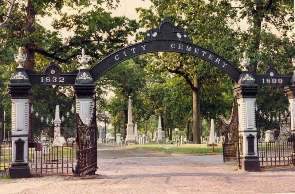 A photo of the South Bend City Cemetery gate and archway from June 2021. The archway is currently under repair after a city vehicle damaged it.