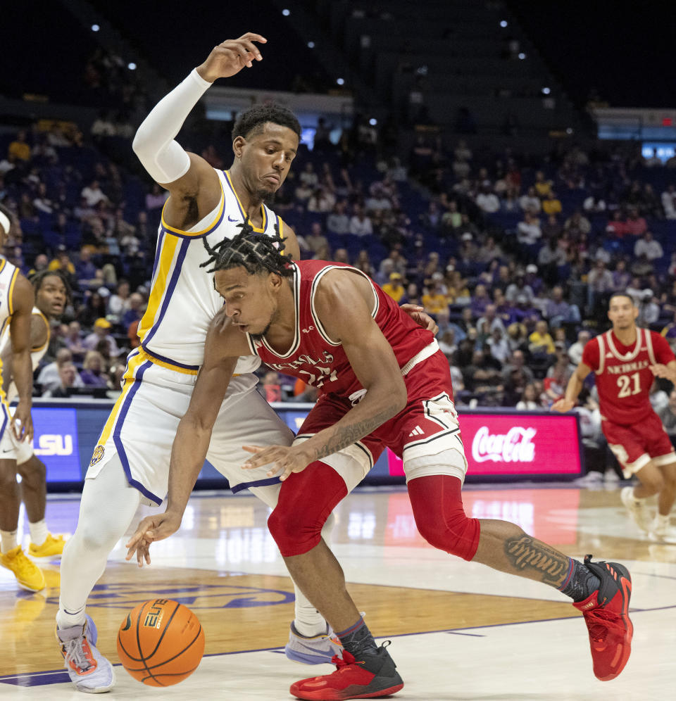 LSU guard Jordan Wright (6) pressures Nicholls forward Jamal West Jr. (15) during an NCAA college basketball game Friday, Nov. 10, 2023, in Baton Rouge, La. (Hilary Scheinuk/The Advocate via AP)