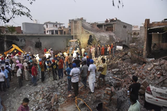 Rescuers work at the site of an explosion at a fireworks factory in Batala, in the northern Indian state of Punjab