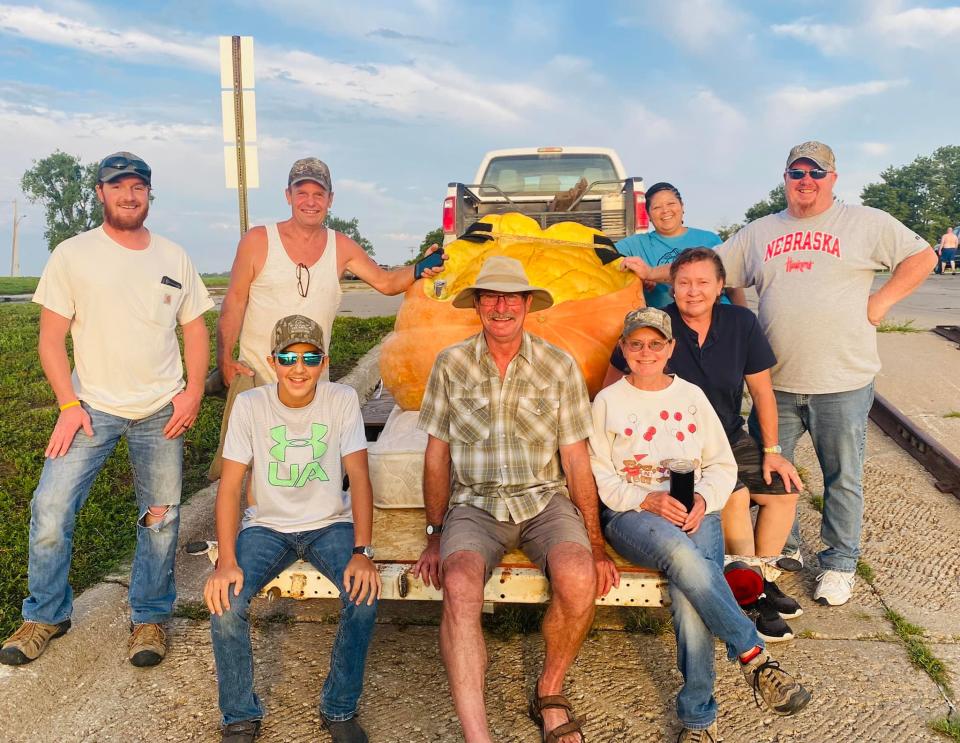 Duane Hansen (second from left in back row) broke a world record by travelling on this nearly 850-pound pumpkin along the Missouri River between Bellevue and Nebraska City. (Photo by Phil Davidson via City of Bellevue, Nebraska on Facebook)