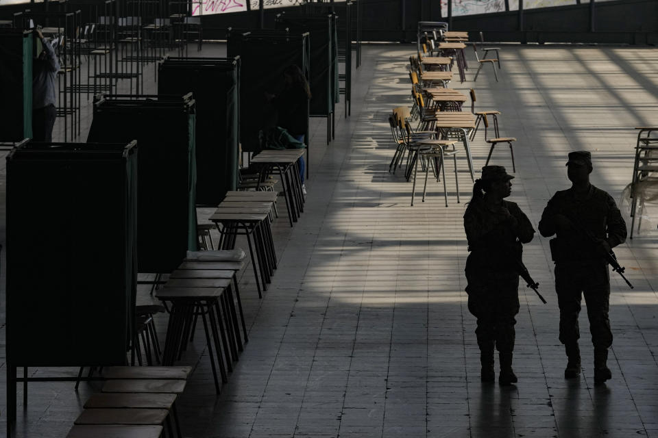 Soldiers guard the old Mapocho train station that is now a cultural center that will be used as a polling station for the Constitutional Council election in Santiago, Chile, Friday, May 5, 2023. The election will be held May 7, after a first attempt to replace the current Constitution bequeathed by the military 42 years ago was rejected by voters in 2022. (AP Photo/Esteban Felix)