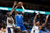 Dallas Mavericks forward Tim Hardaway Jr. (11) goes up for a shot as Los Angeles Lakers forward LeBron James and Los Angeles Lakers guard Lonnie Walker IV (4) contest him in the second half of an NBA basketball game in Dallas, Sunday, Dec. 25, 2022. (AP Photo/Emil T. Lippe)