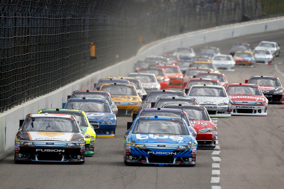 FORT WORTH, TX - NOVEMBER 06: (Lead cars L-R) David Ragan, driver of the #6 UPS My Choice Ford and Greg Biffle, driver of the #16 3M Scotch-Blue Painter's Tape Ford, lead the field at the start of the NASCAR Sprint Cup Series AAA Texas 500 at Texas Motor Speedway on November 6, 2011 in Fort Worth, Texas. (Photo by Jonathan Ferrey/Getty Images)