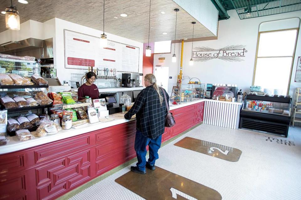 Retail associate Joana Najera waits on a customer at Farmhouse House of Bread reopens in San Luis Obispo.