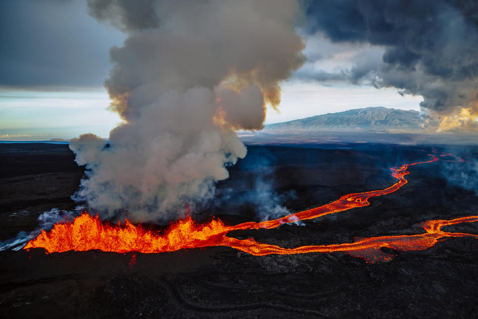 An aerial view of the lava fissures flowing down the Mauna Loa volcano.