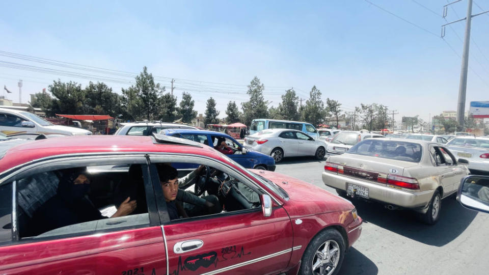 Afghan families carrying belongings on their way to flee Kabul city, Afghanistan, on August 15, 2021.<span class="copyright">Haroon Sabawoon/Anadolu Agency via Getty Images</span>