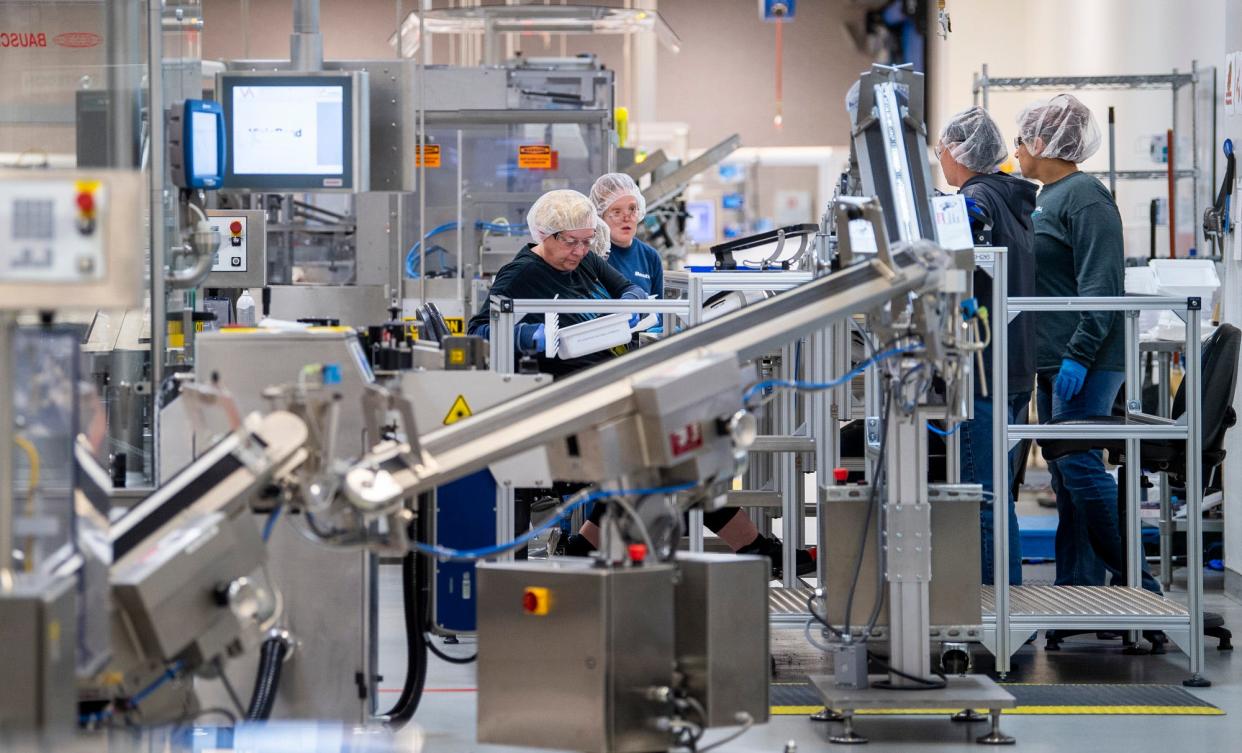 Jama Moody works on a syringe line at Simtra BioPharma Solutions on Thursday, Nov. 10, 2023.