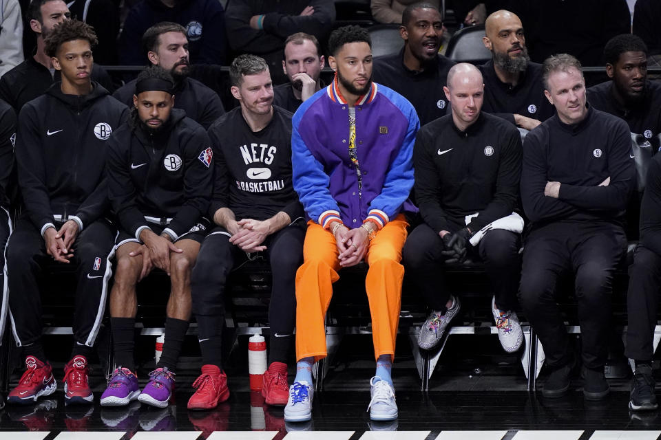 Brooklyn Nets' Ben Simmons, center, sits on the bench during the second half of Game 3 of an NBA basketball first-round playoff series against the Boston Celtics, Saturday, April 23, 2022, in New York. (AP Photo/John Minchillo)