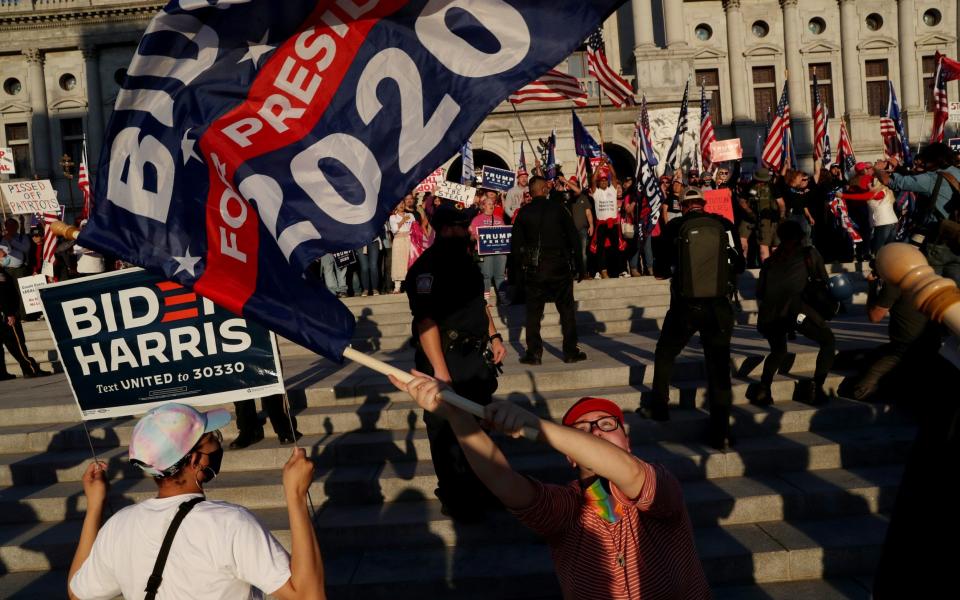 Supporters of Donald Trump faced off with supporters of Joe Biden outside the State Capitol building in Harrisburg, Pennsylvania, after the media declared Mr Biden to be the winner of the 2020 US presidential election on November 7 - REUTERS/Leah Millis