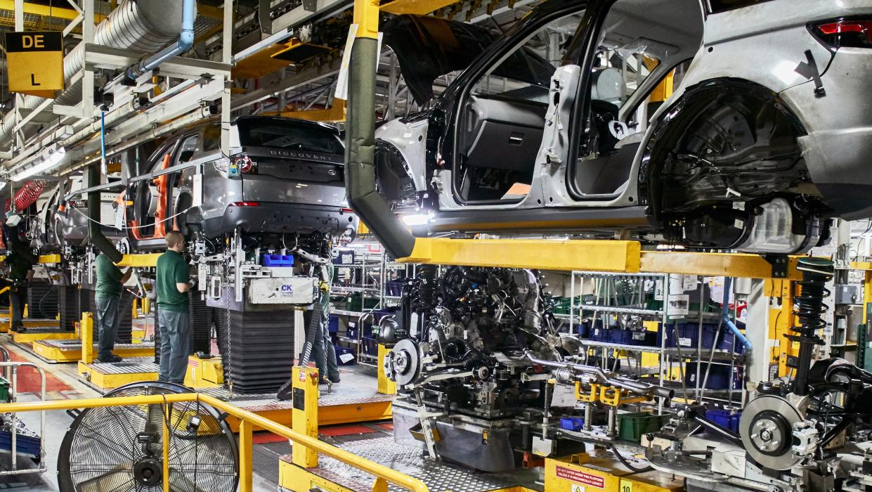 Workers On Engine Production Line In Car Factory. (Photo by: Mahaux Charles/AGF/Universal Images Group via Getty Images)