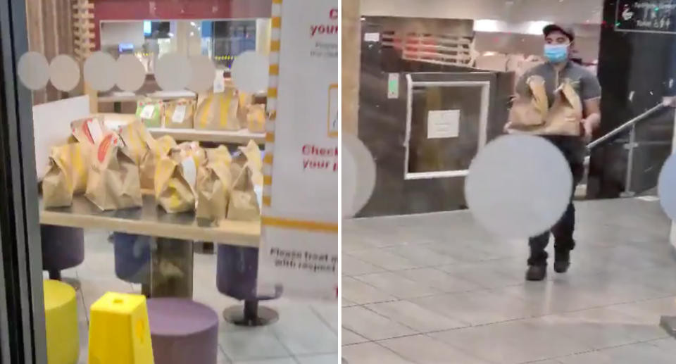 A stack of McDonald's orders are seen on a table as an employee runs more over. 