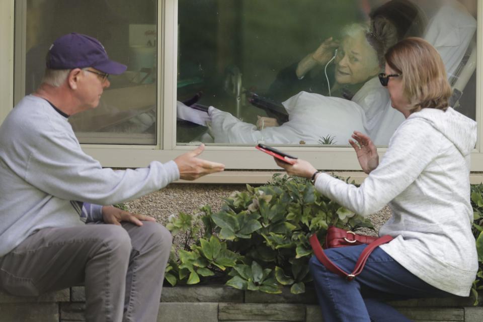 Visit through a window at Life Care Center in Kirkland, Washington