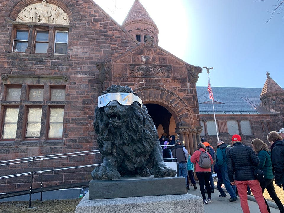 People prepare for the upcoming solar eclipse in front of the Fairbanks Museum and Planetarium in St. Johnsbury, Vermont on April 8, 2024.