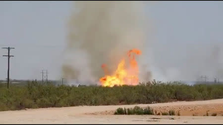 A pipeline explosion erupts in this image captured from video by a field worker in Midland County, the home to the Permian Basin and the largest U.S. oilfield, in Texas, U.S., August 1, 2018. Courtesy Marty Baeza/Handout via REUTERS