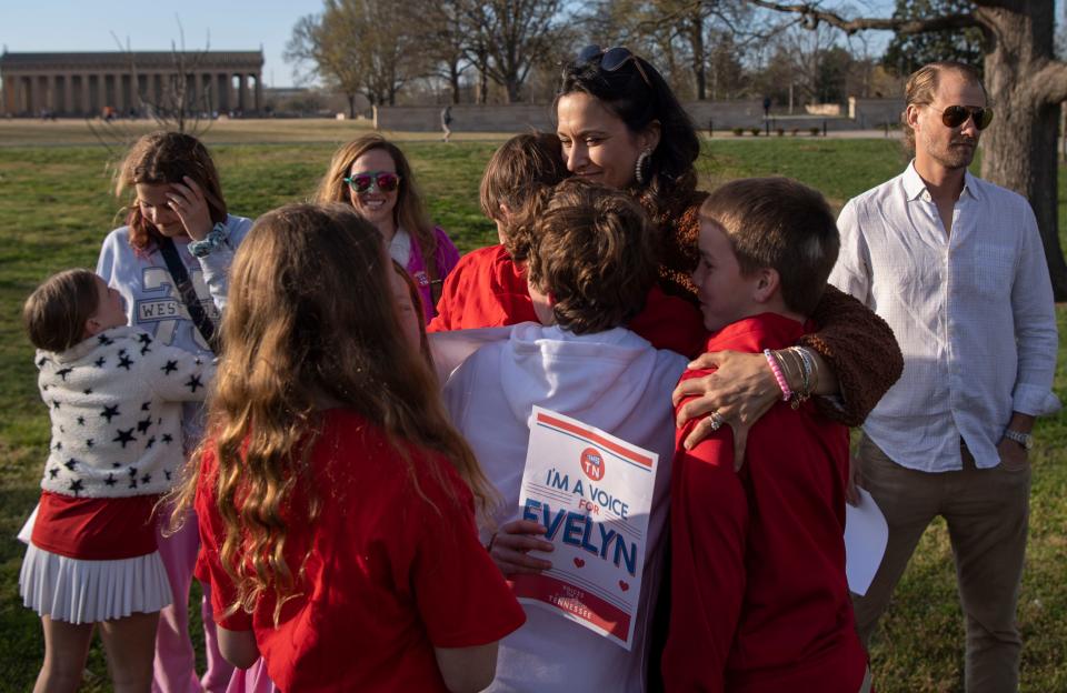 Katy Dieckhaus, mother of, Evelyn Dieckhaus, 9, who was killed during the Covenant School shooting last year, is embraced by a group of children following the Linking Arms for Change, event at Centennial Park in Nashville, Tenn., Wednesday, March 27, 2024. The event was in remembrance of the Covenant School shooting where six people – three children and three adults – were killed last year.