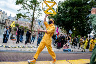 During the new campaign from the climate group Extinction Rebellion in The Netherlands, an 'XR fashion show' was carried out in front of the House of Representatives in The Hague, Netherlands, on September 1, 2020. The models were wearing yellow, black, and white colorful second-hand outfits to symbolize the collectivity of bees, to show that thinking and working together can help us out of this crisis. (Photo by Romy Arroyo Fernandez/NurPhoto via Getty Images)