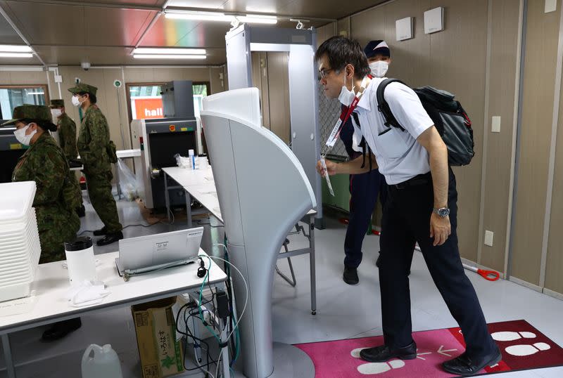 Doctor Shoji Yokobori goes through a security check at Tokyo International Forum