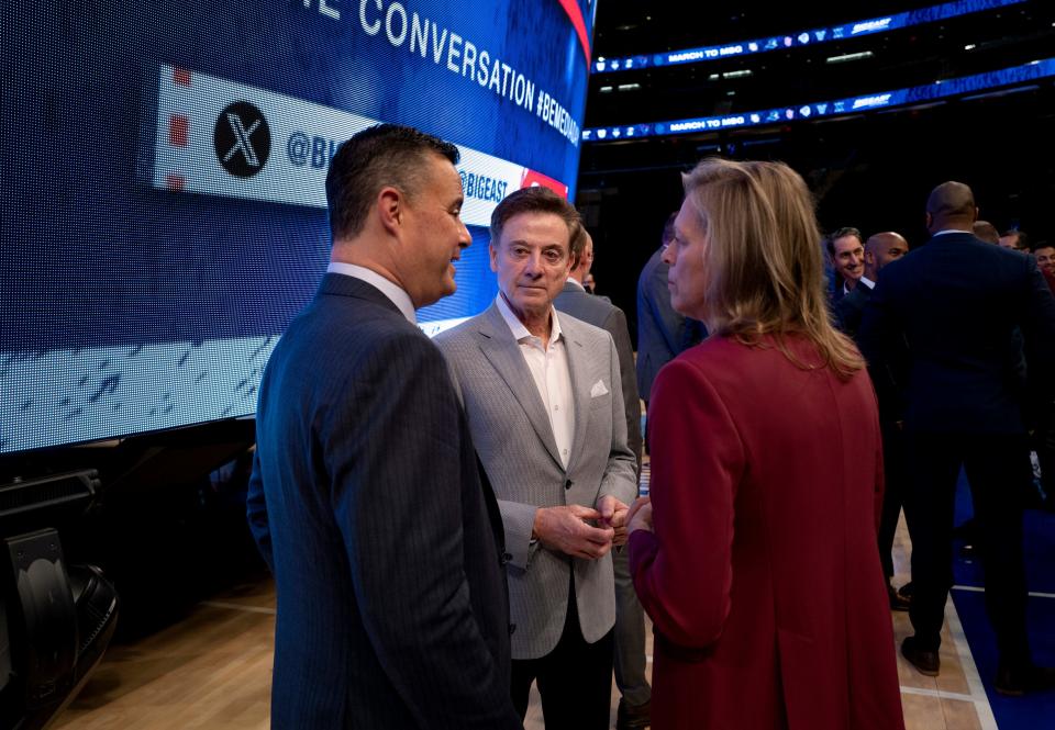 The Big East commissioner, Val Ackerman, right, speaks with St. John's coach Rick Pitino and Xavier coach Sean Miller during the Big East NCAA college basketball media day on Tuesday at Madison Square Garden in New York.