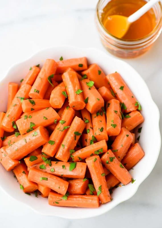 <p>Well Plated</p><p>Sweet and buttery, plus they save room on the stove. Get this <a href="https://www.wellplated.com/crock-pot-honey-carrots/" rel="nofollow noopener" target="_blank" data-ylk="slk:Crock Pot Honey Carrots;elm:context_link;itc:0;sec:content-canvas" class="link ">Crock Pot Honey Carrots</a> recipe!</p>