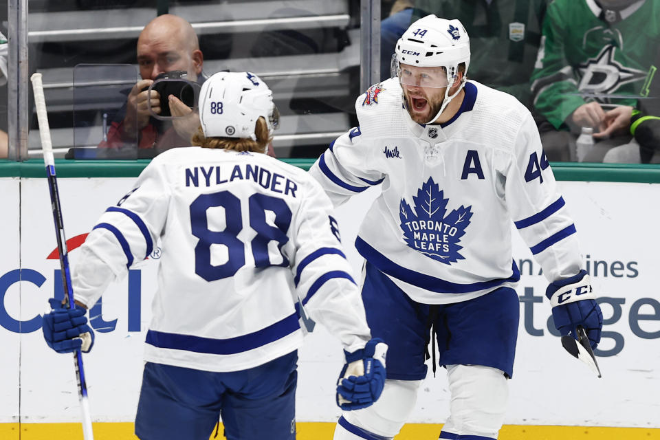 Toronto Maple Leafs defenseman Morgan Rielly (44) is congratulated by forward William Nylander (88) after scoring a goal against the Dallas Stars during the first period of an NHL hockey game Thursday, Oct. 26, 2023, in Dallas. (AP Photo/Brandon Wade)