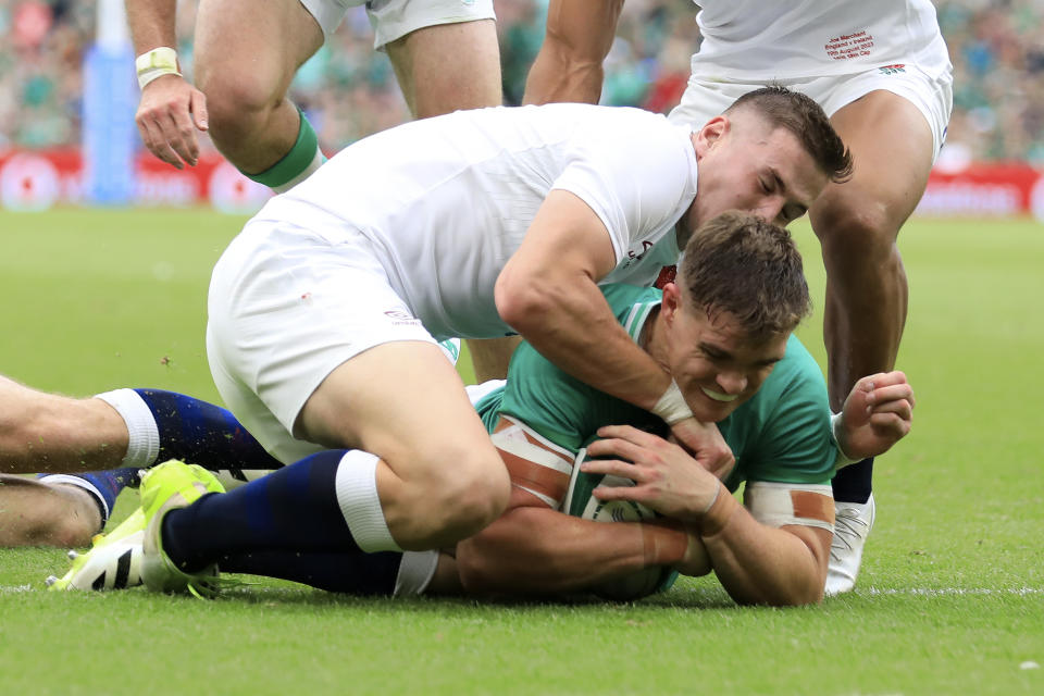 Ireland's Garry Ringrose, right, scores a try as England's Freddie Steward tries to defend during the international rugby union match between Ireland and England, at Aviva Stadium, Dublin, Ireland, Saturday, Aug. 19, 2023. (AP Photo/Peter Morrison)
