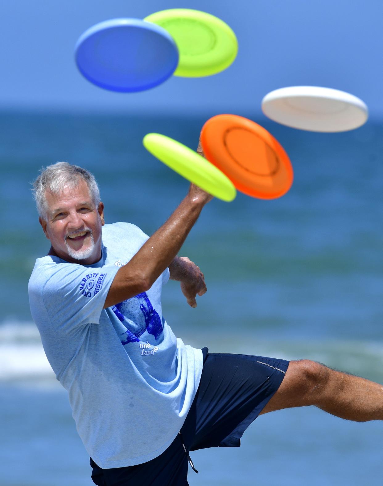 Paul Kenny, an eight-time world champion freestyle Frisbee player from Jacksonville Beach, shows off his skills on a recent day at the beach. Kenny was inducted into the Freestyle Disc Hall of Fame in May.