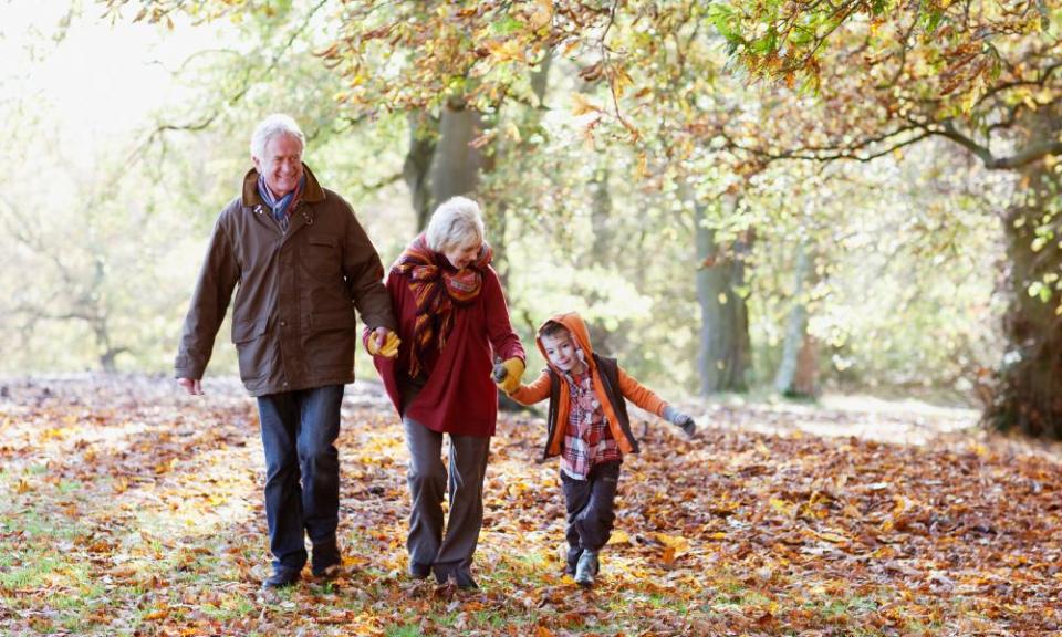 Grandparents playing in park with grandson