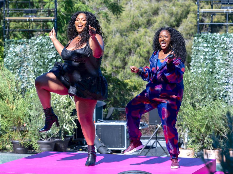 Two women dancing on a stage.