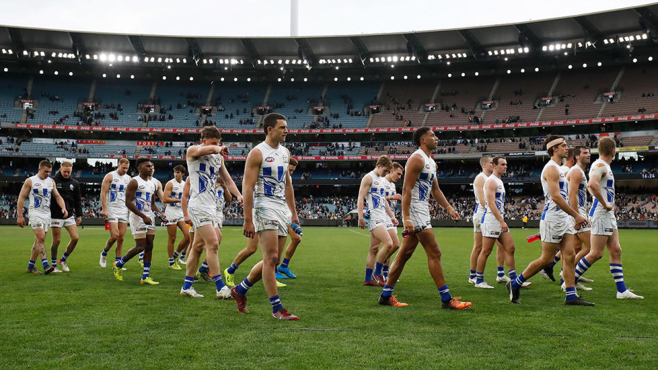 North Melbourne players walk off the ground after their round 17 AFL loss to Collingwood.