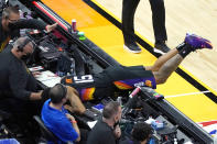 Phoenix Suns guard Cameron Payne (15) dives for a loose ball during the second half of the team's NBA basketball game against the San Antonio Spur on Saturday, April 17, 2021, in Phoenix. (AP Photo/Rick Scuteri)