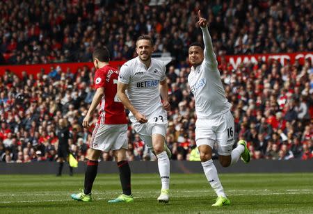 Britain Football Soccer - Manchester United v Swansea City - Premier League - Old Trafford - 30/4/17 Swansea City's Gylfi Sigurdsson celebrates with Martin Olsson after scoring their first goal Action Images via Reuters / Jason Cairnduff Livepic