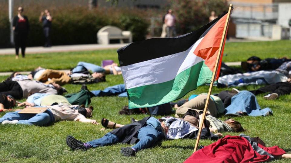 About 70 people gathered on Cal Poly’s Dexter Lawn on May 1, 2024, to stage a silent die-in in support of Palestine. David Middlecamp/dmiddlecamp@thetribunenews.com