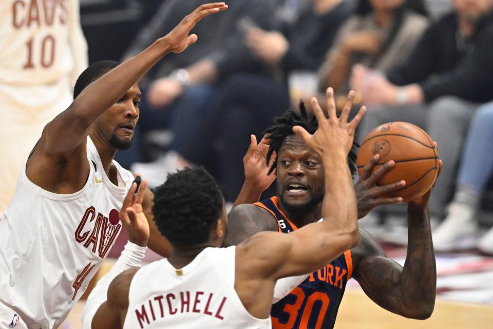 Apr 26, 2023; Cleveland, Ohio, USA; Cleveland Cavaliers forward Evan Mobley (4) and guard Donovan Mitchell (45) defend New York Knicks forward Julius Randle (30) in the first quarter during game five of the 2023 NBA playoffs at Rocket Mortgage FieldHouse. Mandatory Credit: David Richard-USA TODAY Sports