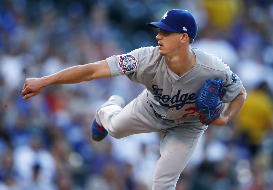 Los Angeles Dodgers starting pitcher Walker Buehler works against the Colorado Rockies in the first inning of a baseball game Saturday, Aug. 11, 2018, in Denver. (AP Photo/David Zalubowski)