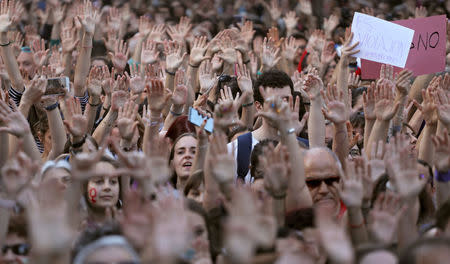 People shout slogans during a protest outside Ministry of Justice after a Spanish court condemned five men accused of the group rape of an 18-year-old woman at the 2016 San Fermin bull running festival to nine years in prison each for the lesser crime of sexual abuse in Madrid, Spain, April 26, 2018. REUTERS/Sergio Perez