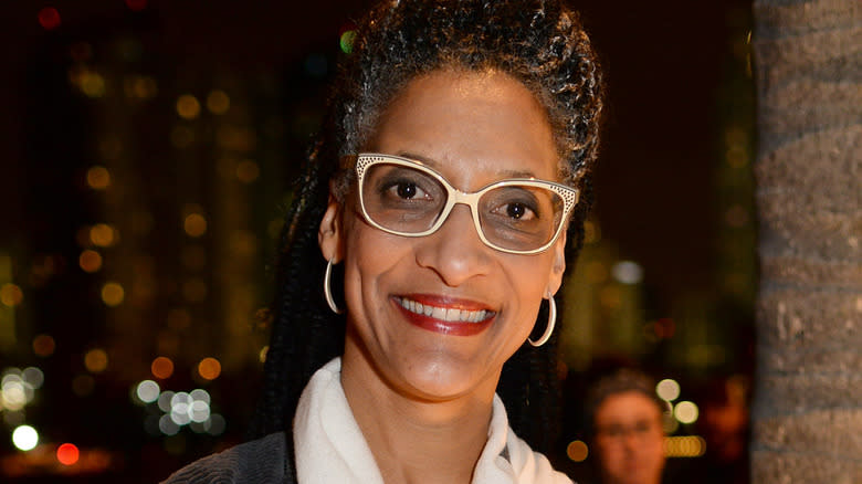 carla hall smiling into camera white glasses