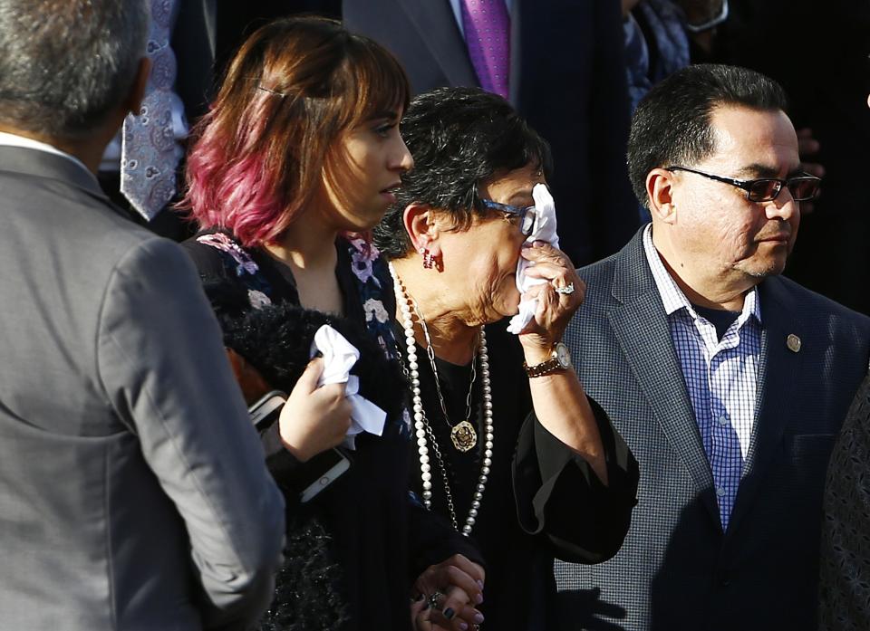 Verma Pastor, middle, wife of former Democratic U.S. Rep. Ed Pastor, wipes away tears outside of St. Francis Xavier Catholic Church after a funeral for her husband Friday, Dec. 7, 2018, in Phoenix. Rep. Pastor was Arizona's first Hispanic member of Congress, spending 23 years in Congress before retiring in 2014. Rep. Pastor passed away last week at the age of 75. (AP Photo/Ross D. Franklin)