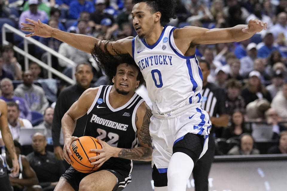 Providence guard Devin Carter (22) tries to get past Kentucky forward Jacob Toppin 90) during the second half of a first-round college basketball game in the NCAA Tournament on Friday, March 17, 2023, in Greensboro, N.C. (AP Photo/John Bazemore)