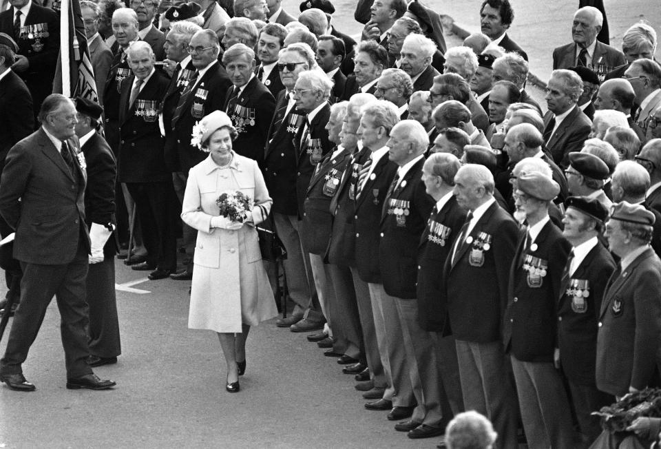 FILE - A smiling Queen Elizabeth II passes in front of British veterans during a ceremony in Arromanches, France, June 7, 1984, for the 40th anniversary of the D-Day landing. Queen Elizabeth II's death in September 2022 was arguably the most high-profile death this year. In her 70 years on the British throne, she helped modernize the monarchy across decades of enormous social change, royal marriages and births, and family scandals. For most Britons, she was the only monarch they had ever known. (AP Photo, File)
