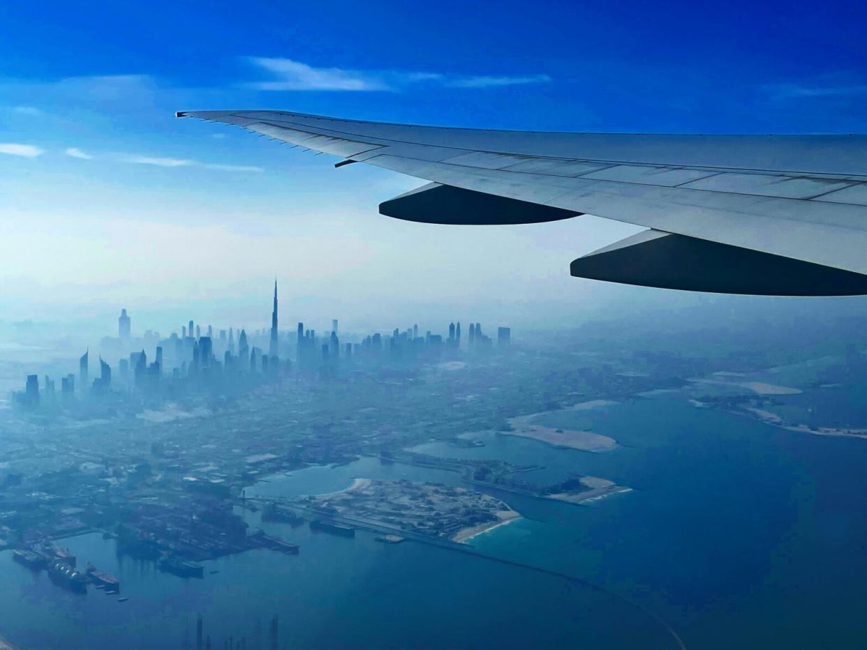 Check out a recent announcement that covers new construction on a popular airport. pictured: an airplane flying over Dubai