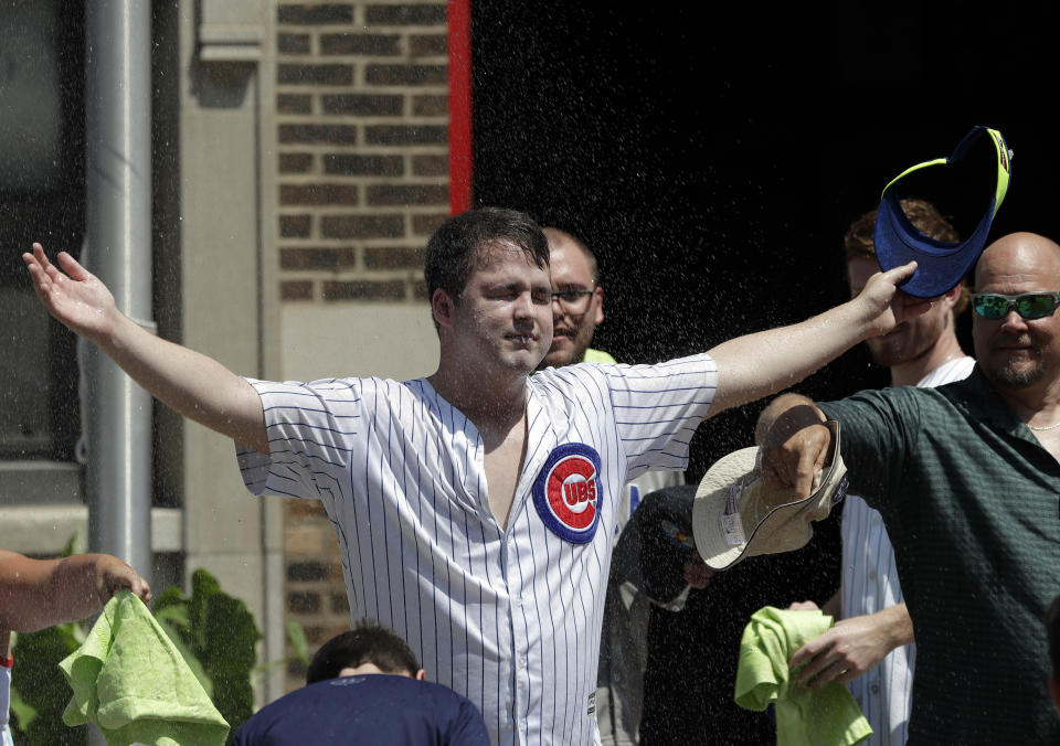 Chicago Cubs fans cool off before a baseball game between the San Diego Padres and the Chicago Cubs in Chicago, Saturday, July 20, 2019. Storms on Thursday postponed excessive heat warnings that went into effect at 10 a.m. Friday for Cook County and all of northern Illinois, southern Wisconsin and northwest Indiana. The worst of the heat was expected to pass by 7 p.m. Saturday. (AP Photo/Nam Y. Huh)