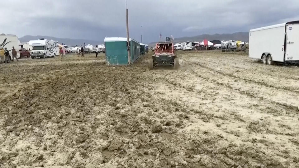 CORRECTS THAT THE SOURCE IS STRINGR, NOT REBECCA BARGER - In this image from video provided by Stringr, a vehicle drives through mud at the Burning Man festival site in Black Rock, Nev., on Monday, Sept. 4, 2023. An unusual late-summer storm stranded thousands at the week-long event. (Stringr via AP)