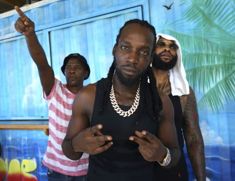 Jamaican dancehall star Mavado (C) joined in the street festivities