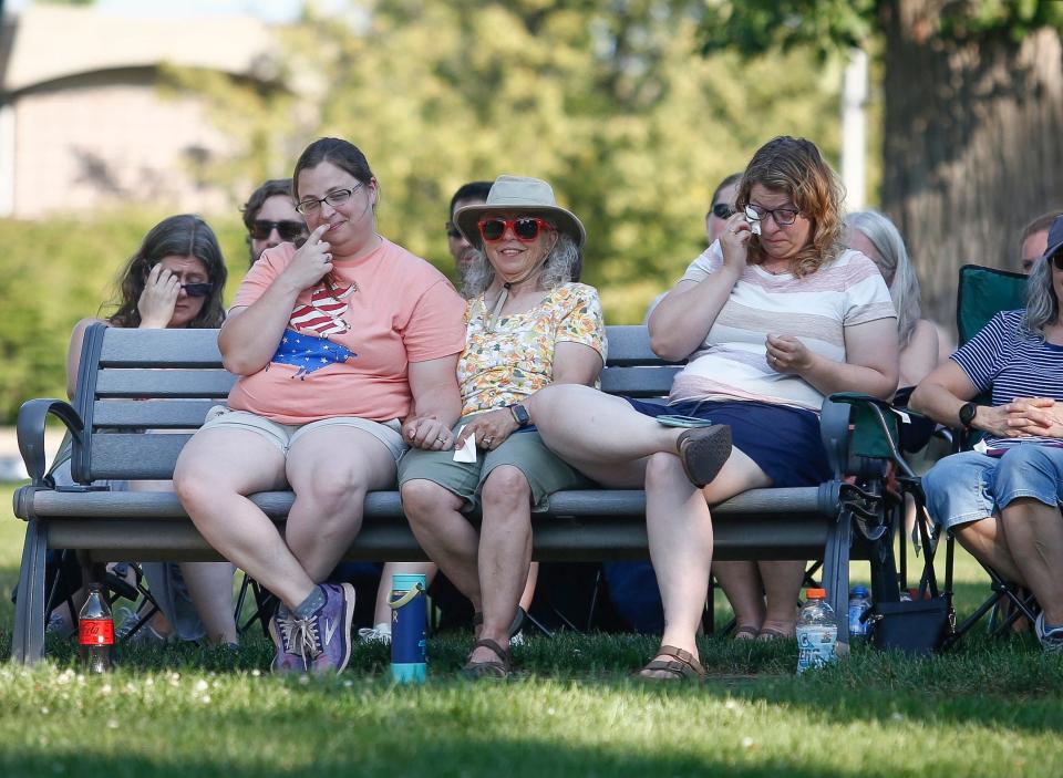 Karen Moorehouse, left, is joined by her sister, Jana, right and their mother, Jean, during a celebration of life service on Tuesday, Aug. 2, 2022, for Tyler and Sarah Schmidt and their 6-year-old daughter, Lula, who were killed in a shooting in the Maquoketa Caves State Park.