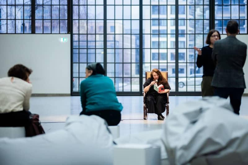 Tania Bruguera, artist and activist, reads from Hannah Arendt's "Elements and Origins of Totalitarianism" before a press event for her performance "Where Your Ideas Become Civic Actions (100 Hours Reading The Origins of Totalitarianism)" at Hamburger Bahnhof - Nationalgalerie der Gegenwart. Christoph Soeder/dpa