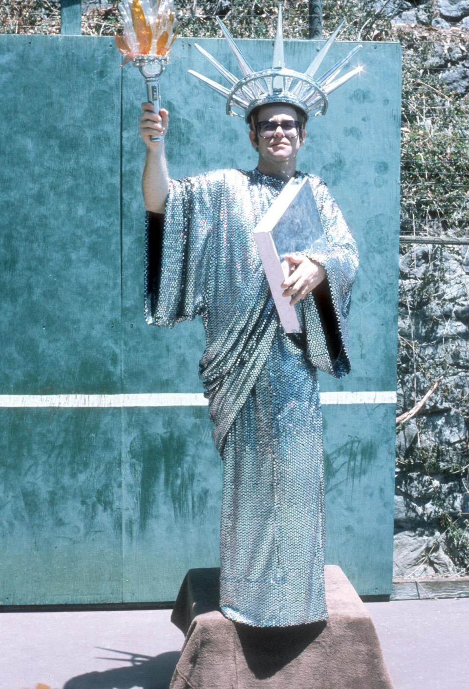 Elton John wears a  Statue Of Liberty costume for a portrait session in circa 1980 (Photo by Michael Ochs Archives/Getty Images)