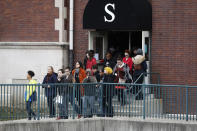 <p>Students exit the building before gathering on their soccer field during a 17-minute walkout protest at the Stivers School for the Arts, Wednesday, March 14, 2018, in Dayton, Ohio. Students across the country planned to participate in walkouts Wednesday to protest gun violence, one month after the deadly shooting inside a high school in Parkland, Fla. (Photo: John Minchillo/AP) </p>